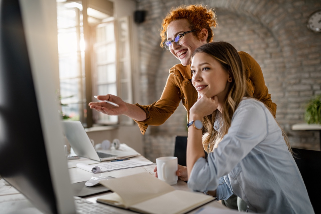 Two marketers reviewing results on a screen together